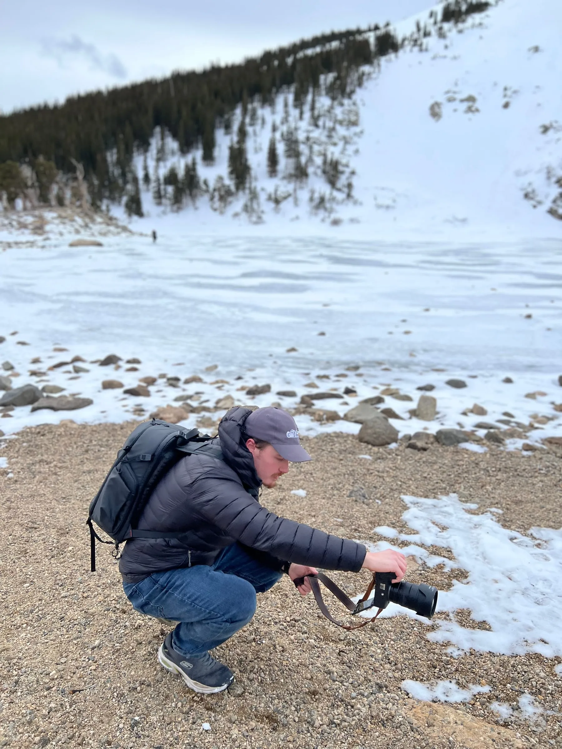 Christian crouched low on the shoreline, working out an angle