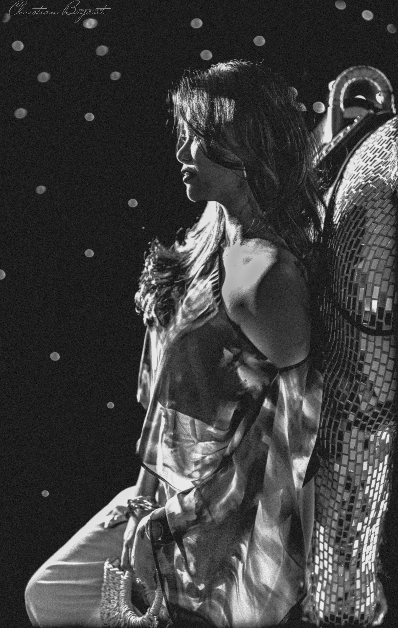 Woman beside a mirror ball